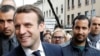 Emmanuel Macron, left, is campaigns for the 2017 presidential election, flanked by Alexandre Benalla, right, head of security, in Rodez, France, May 5, 2017.